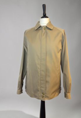 an image of a tan shirt on a mannequin stand