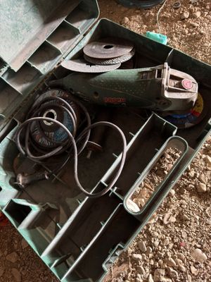 a tool box with tools in it sitting on the ground