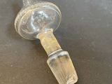a glass bottle with a glass stopper attached to it