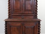 an old wooden cabinet with two doors and a drawer on top of it