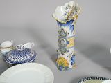 many plates and cups and a vase on the table