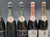 six bottles of champagne sitting next to each other on a table