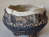 a black and white bowl sitting on top of a table