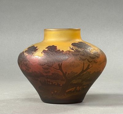 a vase with a painting on it sitting on a table