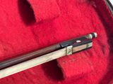 a wooden stick in a case on a red cloth
