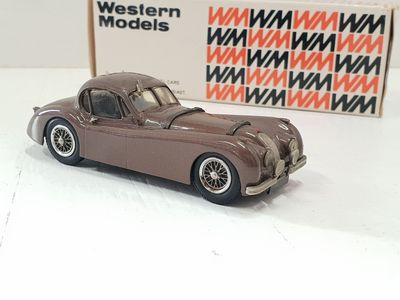 a toy car sitting next to a box of western models
