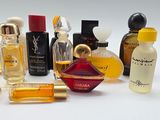 many different types of perfume bottles on a white surface