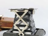 a small camera sitting on top of an old suitcase