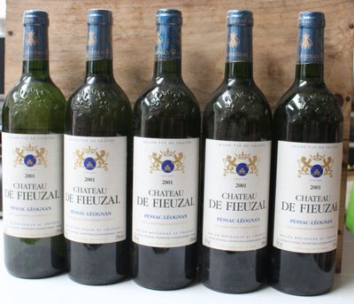 six bottles of wine are lined up in a row on a table