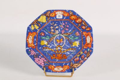 a blue plate with a design of flowers and birds on it