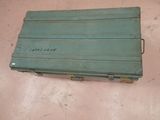 a green crate with writing on it sitting on the floor