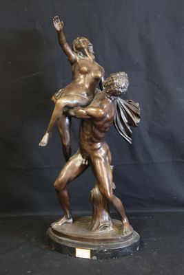 bronze statue of a man holding a woman on his back