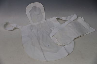 a white apron and bib laying on a table