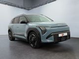 a blue suv parked in a garage with a white wall