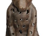 a statue of a cat with holes in it ' s body