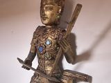 a statue of a man holding a knife and a bowl