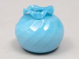 a small blue vase with a bow on the top of it