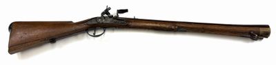 an old rifle with a wooden barrel on a white background