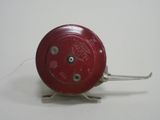 a close up of a small red object on a white surface