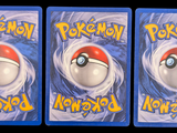 three cards with pokemon on them on a black background