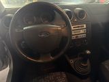 a dashboard of a car with a steering wheel and dashboard controls