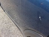 a close up of a car ' s door handle with a sticker on it