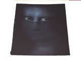 a black picture of a man ' s face on a sheet of paper