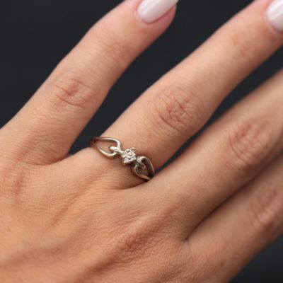 an image of a woman ' s hand with a ring on it
