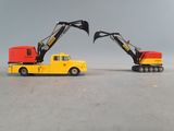 two toy trucks that are sitting next to each other