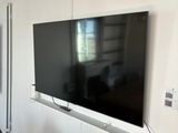 a flat screen tv mounted on the wall in the living room