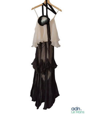 a black and white dress hanging on a hanger