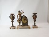 three bronze figurines of a woman and a clock