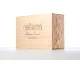 a wooden box with a wine bottle in it sitting on a table
