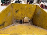 a box in the back of a yellow dump truck