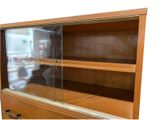 a glass display case in the middle of a wooden cabinet