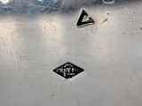 a close up of a silver plate with a black diamond on it