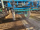 a blue tractor that is parked on the side of the road