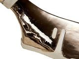 a knife that is laying on top of a piece of metal