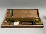 an old brass telescope in a wooden case with a white cloth