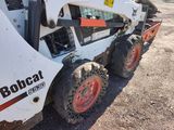 a picture of a bobcat ski - door parked on the side of the road