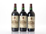 three bottles of wine sitting on top of a white surface
