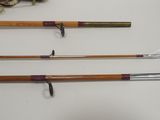 three old fishing rods and a fishing line on a table