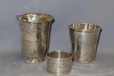 three silver cups sitting next to each other on a table