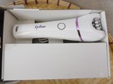 a white electric shaver in a box on a table