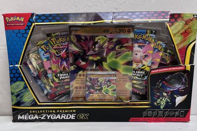 the box contains a collection of pokemon cards and a card case
