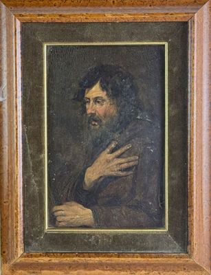 portrait d'un homme barbu vêtu d'un manteau marron, encadré dans un cadre en bois