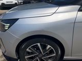 a silver car parked in a parking lot with other cars in the background