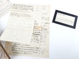 a box of old papers and a picture frame on a table