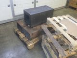 a black box sitting on top of a pallet in a garage