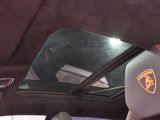 a view of a car ' s sunroof from inside the car